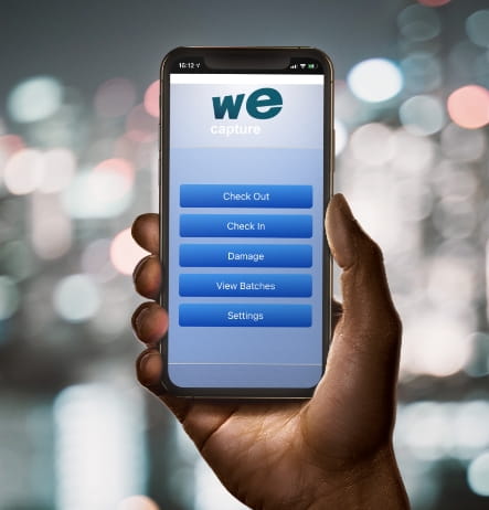 Photo of hand holding phone with the We-Capture app on the screen